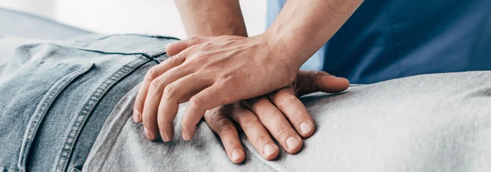 A chiropractor adjusting a patient's lower back