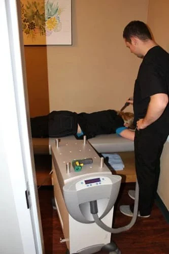 A patient at Advanced Spine Joint & Wellness Center receiving laser treatment